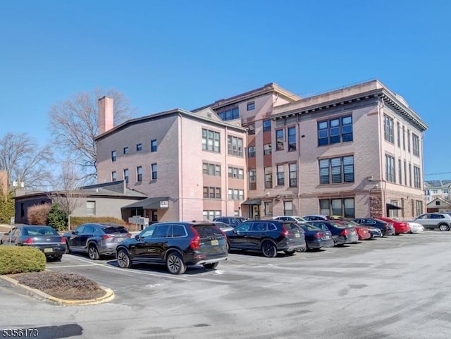 view of building exterior featuring uncovered parking