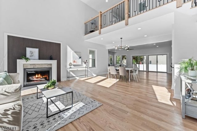 2227 Pine Ter, Scotch Plains Twp, NJ 07076 - living room with wood finished floors, a glass covered fireplace, a chandelier, a high ceiling, and recessed lighting