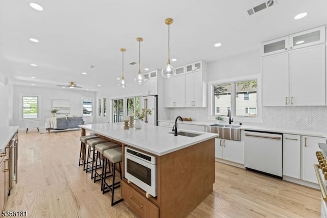 2227 Pine Ter, Scotch Plains Twp, NJ 07076 - kitchen featuring white appliances, a sink, a center island with sink, light wood-type flooring, and recessed lighting