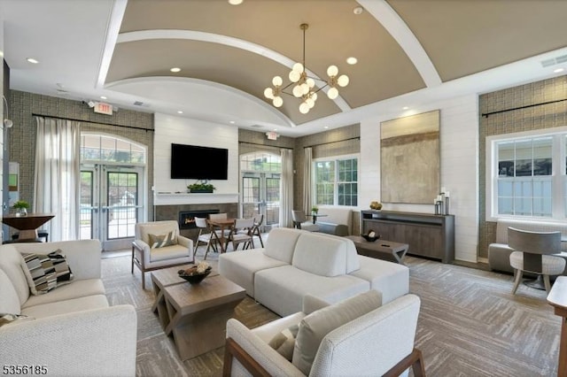 2 Lee Dr, Morris Twp, NJ 07960 - living area with recessed lighting, vaulted ceiling, a glass covered fireplace, and a chandelier