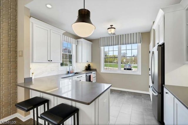 2 Lee Dr, Morris Twp, NJ 07960 - kitchen featuring a sink, appliances with stainless steel finishes, baseboards, tasteful backsplash, and white cabinets