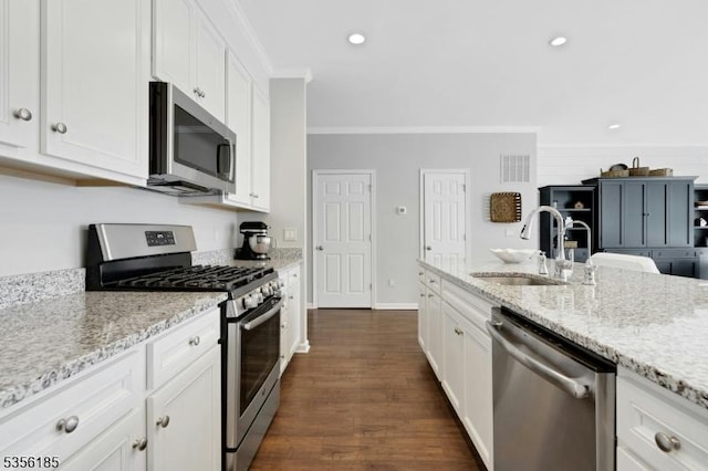 2 Lee Dr, Morris Twp, NJ 07960 - kitchen with stainless steel appliances, a sink, ornamental molding, white cabinetry, and light stone counters