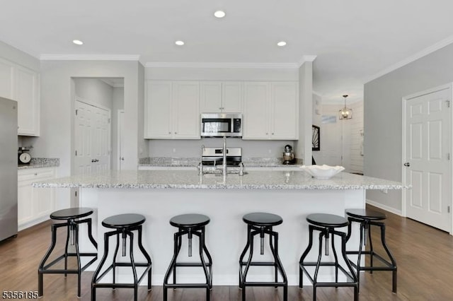 2 Lee Dr, Morris Twp, NJ 07960 - kitchen featuring stainless steel appliances, a sink, white cabinetry, a kitchen breakfast bar, and ornamental molding