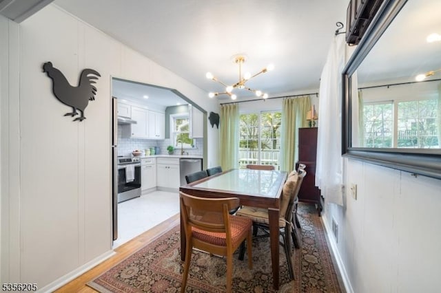 dining room featuring a chandelier and light wood-type flooring