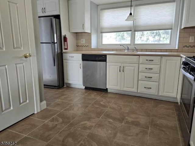 899 Robin Rd Unit 899, Hillsborough Twp, NJ 08844 - kitchen with appliances with stainless steel finishes, a sink, white cabinets, backsplash, and light countertops