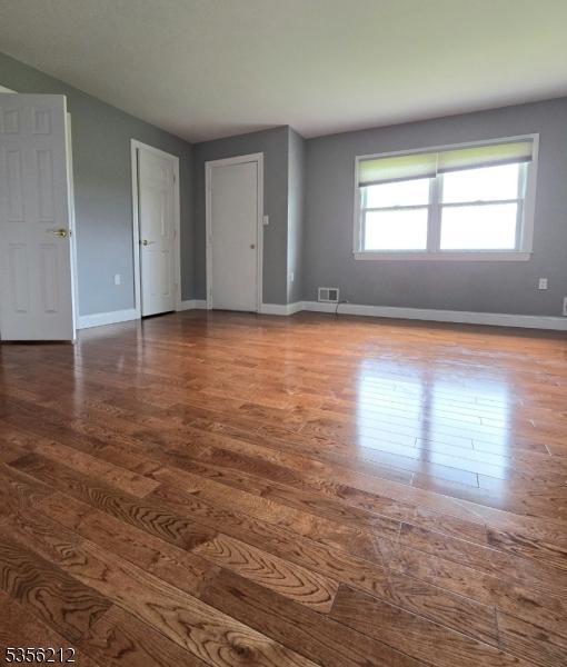 899 Robin Rd Unit 899, Hillsborough Twp, NJ 08844 - empty room with wood finished floors and baseboards
