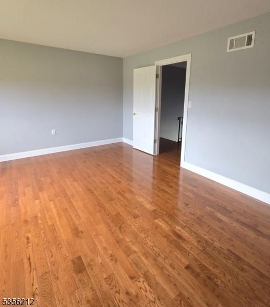 899 Robin Rd Unit 899, Hillsborough Twp, NJ 08844 - spare room featuring wood finished floors and baseboards