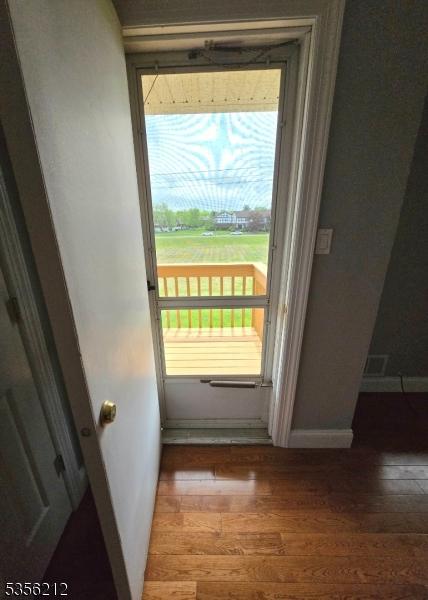 899 Robin Rd Unit 899, Hillsborough Twp, NJ 08844 - doorway to outside featuring wood finished floors and baseboards