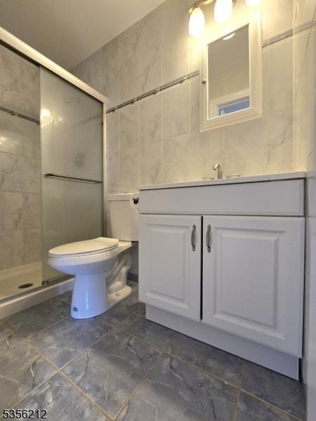 899 Robin Rd Unit 899, Hillsborough Twp, NJ 08844 - bathroom featuring tile walls, a shower stall, vanity, toilet, and marble look tiles