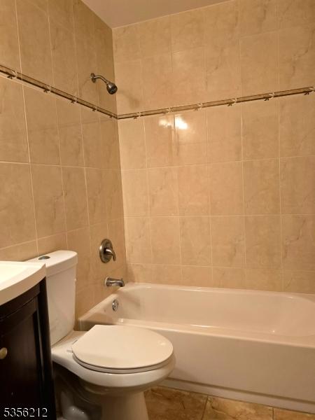899 Robin Rd Unit 899, Hillsborough Twp, NJ 08844 - bathroom featuring tile walls, toilet,  shower combination, vanity, and tile patterned flooring