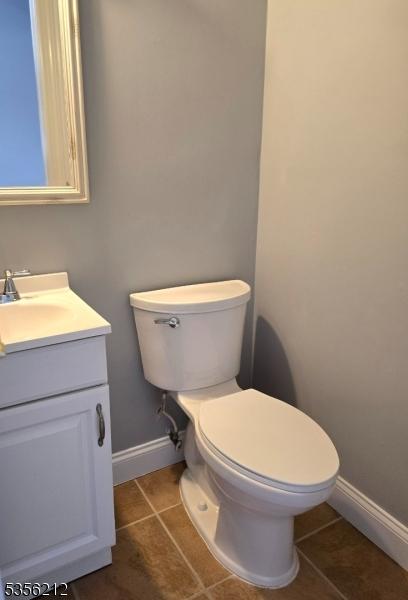 899 Robin Rd Unit 899, Hillsborough Twp, NJ 08844 - half bathroom featuring tile patterned floors, baseboards, toilet, and vanity