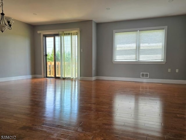 899 Robin Rd Unit 899, Hillsborough Twp, NJ 08844 - unfurnished room featuring plenty of natural light, hardwood / wood-style floors, and a chandelier