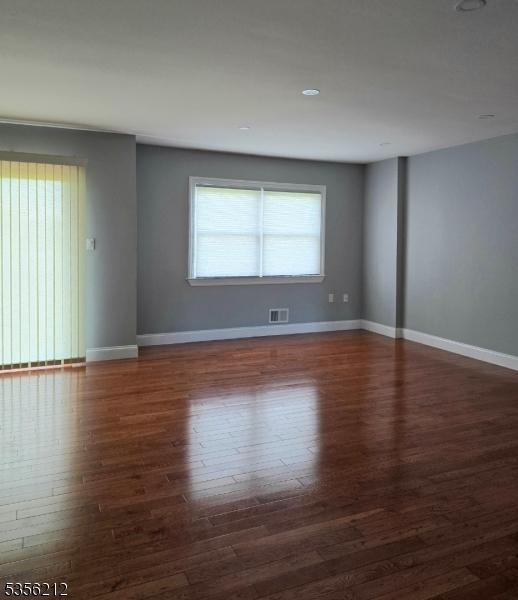 899 Robin Rd Unit 899, Hillsborough Twp, NJ 08844 - empty room featuring wood finished floors and baseboards