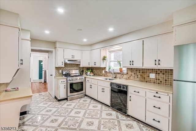 kitchen with stainless steel appliances, a sink, light countertops, under cabinet range hood, and white cabinetry