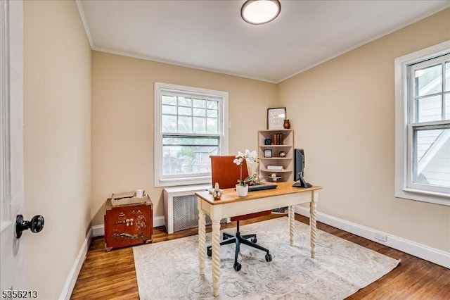 home office featuring ornamental molding, wood finished floors, radiator, and baseboards
