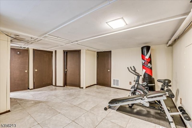 exercise area featuring light tile patterned flooring