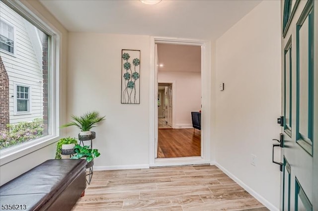 foyer with baseboards and light wood finished floors
