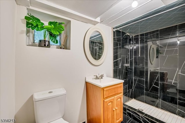 full bathroom featuring toilet, a shower stall, and vanity