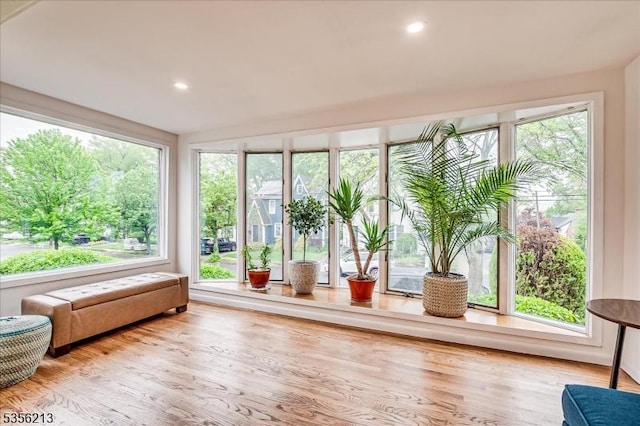 sunroom with wood finished floors, healthy amount of natural light, and recessed lighting