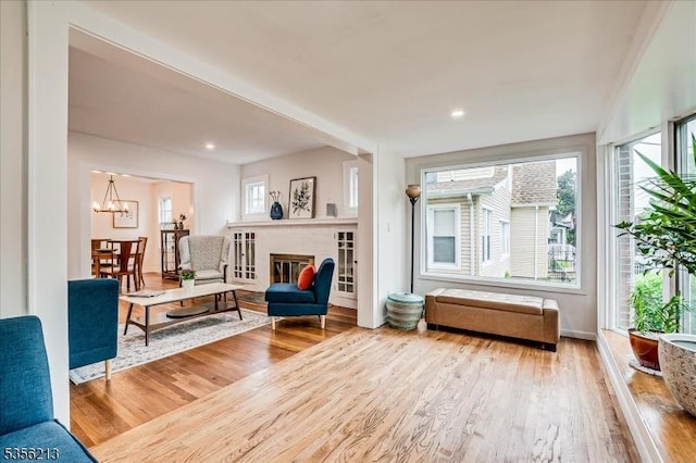 sitting room featuring wood finished floors, a chandelier, and recessed lighting