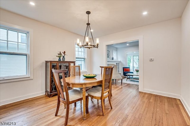 dining space with a chandelier, light wood-style floors, baseboards, and recessed lighting