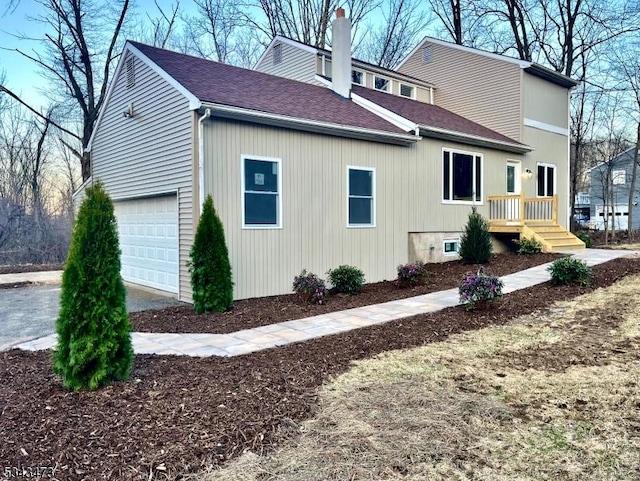 37 Snover Rd, Wantage Twp, NJ 07461 - view of property exterior with a garage, roof with shingles, and a chimney