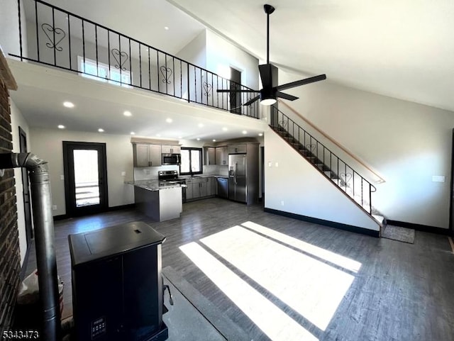 37 Snover Rd, Wantage Twp, NJ 07461 - unfurnished living room with stairs, dark wood-style flooring, a ceiling fan, a towering ceiling, and baseboards