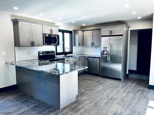 37 Snover Rd, Wantage Twp, NJ 07461 - kitchen featuring appliances with stainless steel finishes, a peninsula, dark stone counters, dark wood-style flooring, and recessed lighting