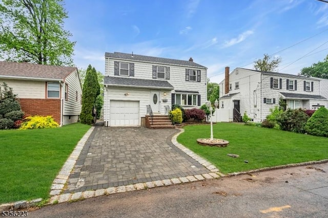 548 Birchwood Rd, Linden City, NJ 07036 - view of front of home with driveway, an attached garage, a front yard, and a chimney