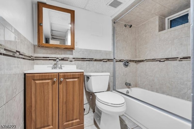 548 Birchwood Rd, Linden City, NJ 07036 - bathroom featuring tile walls, tile patterned flooring, shower / bath combination, vanity, and toilet