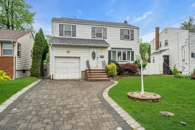 548 Birchwood Rd, Linden City, NJ 07036 - traditional-style house featuring a front yard, decorative driveway, an attached garage, and a chimney