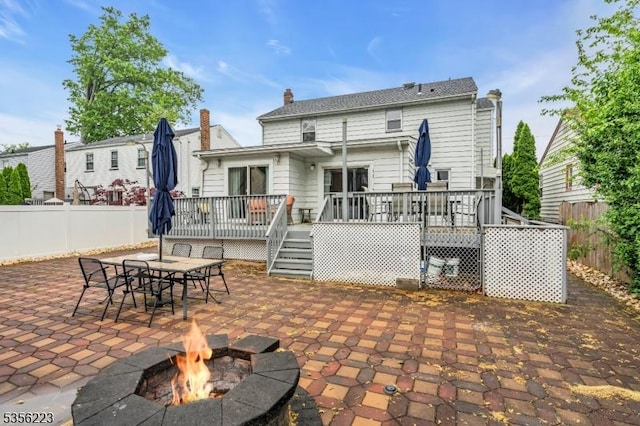 548 Birchwood Rd, Linden City, NJ 07036 - rear view of house featuring a deck, a patio, a fire pit, and fence