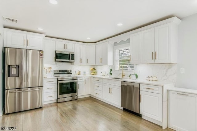 10 Longview Rd, Andover Twp, NJ 07860 - kitchen with stainless steel appliances, a sink, white cabinets, light countertops, and recessed lighting