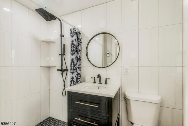 10 Longview Rd, Andover Twp, NJ 07860 - full bathroom with tile walls, tiled shower, vanity, and toilet