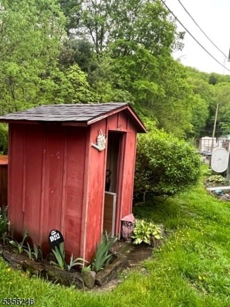 view of shed featuring a wooded view