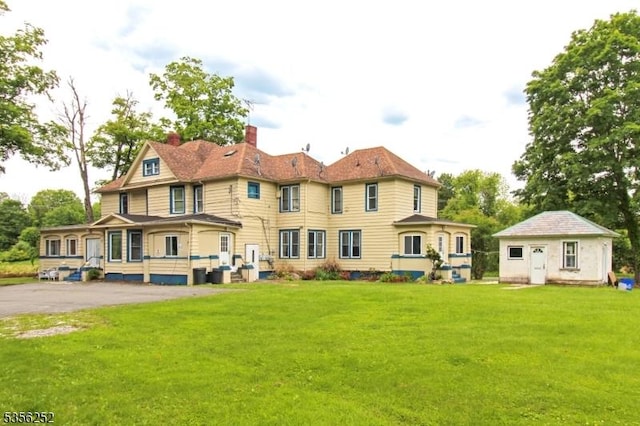 111 Decker Pond Rd, Green Twp, NJ 07821 - rear view of house featuring a chimney and a lawn