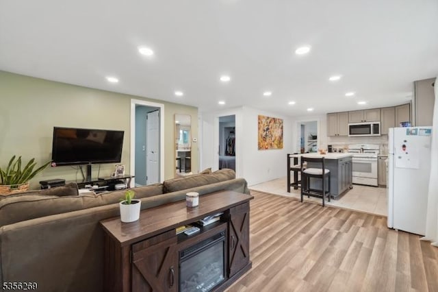 living room with recessed lighting and light wood-style floors
