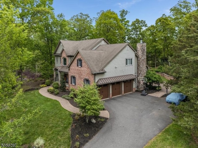30 Southgate Dr, Clinton Twp, NJ 08801 - view of front of property featuring a garage, asphalt driveway, metal roof, a chimney, and a standing seam roof