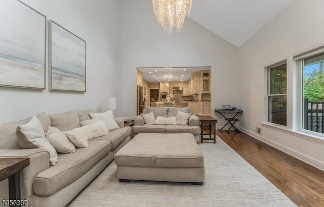 30 Southgate Dr, Clinton Twp, NJ 08801 - living room featuring a chandelier, wood finished floors, high vaulted ceiling, and baseboards