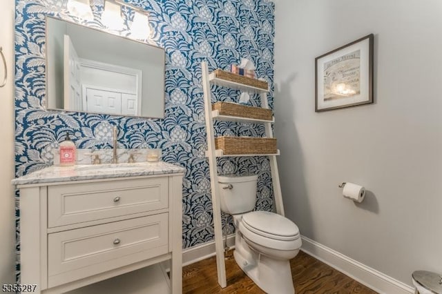 30 Southgate Dr, Clinton Twp, NJ 08801 - half bath with baseboards, toilet, wood finished floors, vanity, and wallpapered walls