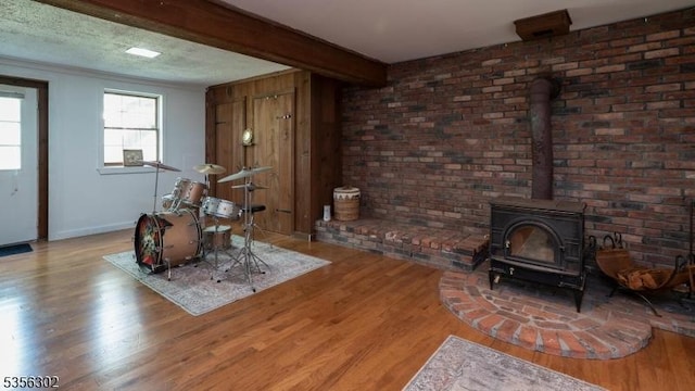 6 Longview Ln, Vernon Twp, NJ 07461 - living area featuring wood finished floors, a wood stove, beam ceiling, and baseboards