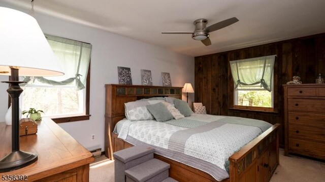 6 Longview Ln, Vernon Twp, NJ 07461 - bedroom featuring light colored carpet, wooden walls, a ceiling fan, and a baseboard radiator
