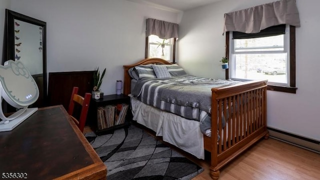6 Longview Ln, Vernon Twp, NJ 07461 - bedroom with multiple windows, wood finished floors, and a baseboard heating unit