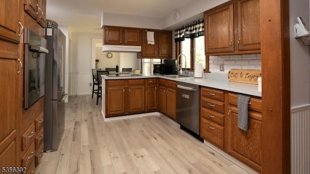 6 Longview Ln, Vernon Twp, NJ 07461 - kitchen with appliances with stainless steel finishes, brown cabinets, light countertops, a sink, and light wood-type flooring