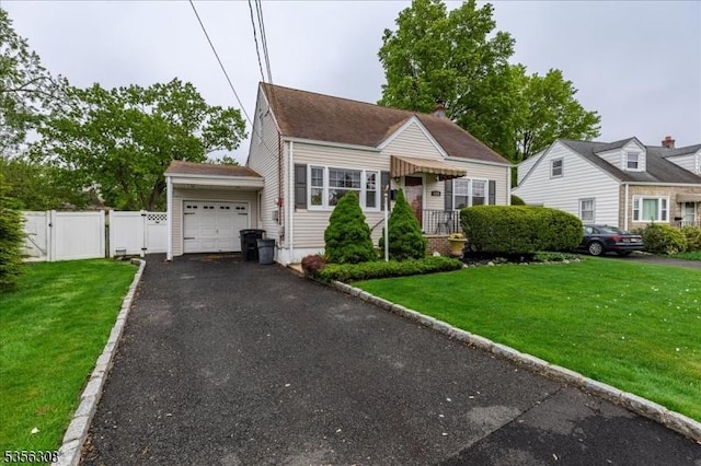 view of front of property with an attached garage, a gate, and driveway