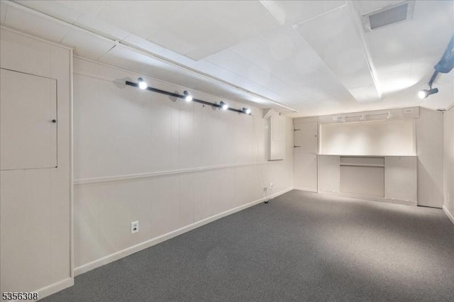 below grade area featuring baseboards and carpet floors