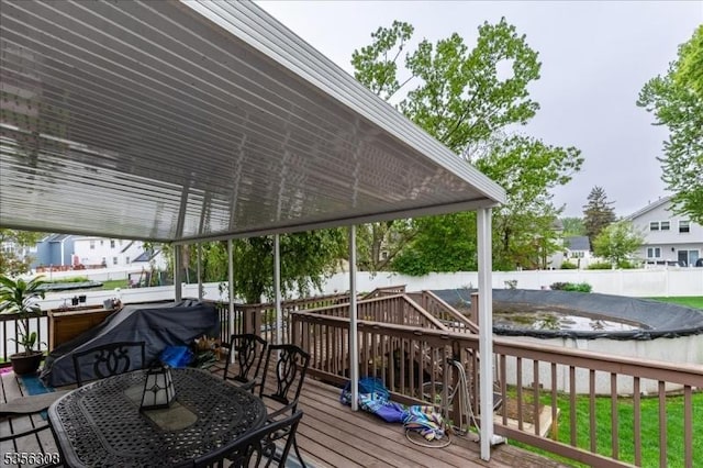 deck featuring a fenced backyard and outdoor dining space