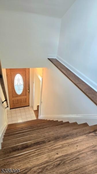 stairs with baseboards and lofted ceiling