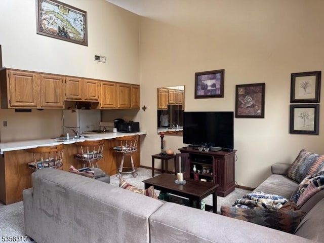 8 Le Touquet Unit 4, Vernon Twp, NJ 07462 - living area with a towering ceiling and light colored carpet