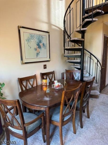 8 Le Touquet Unit 4, Vernon Twp, NJ 07462 - carpeted dining space with stairs
